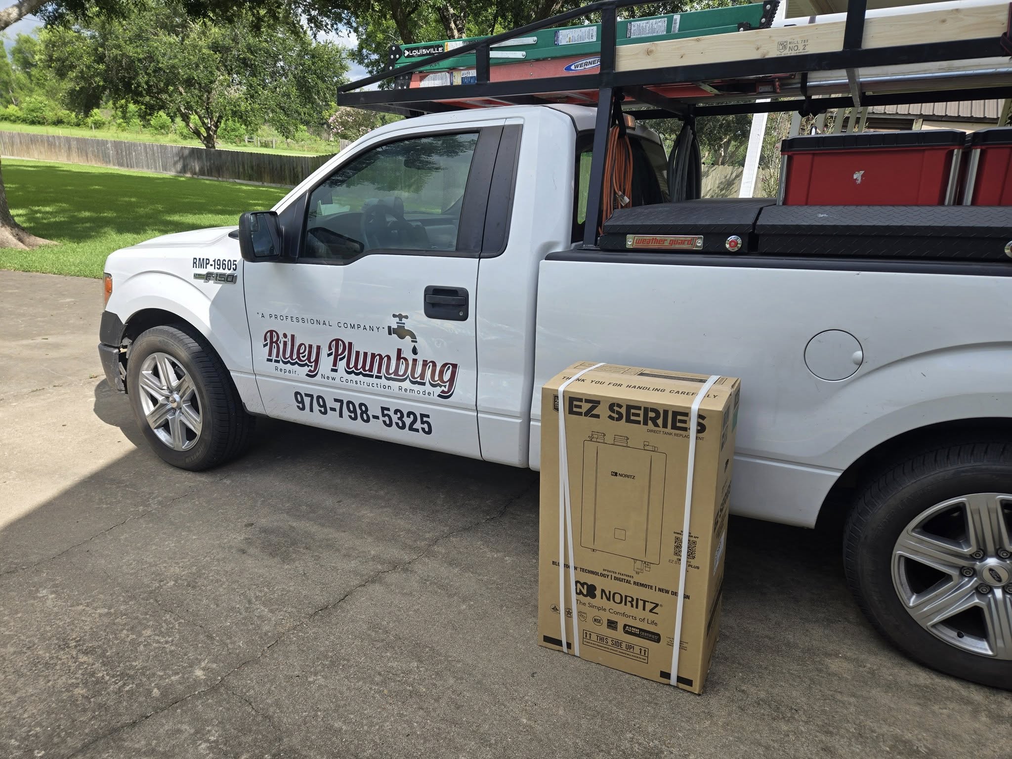 Riley Plumbing service truck with a Noritz EZ Series tankless water heater ready for installation.