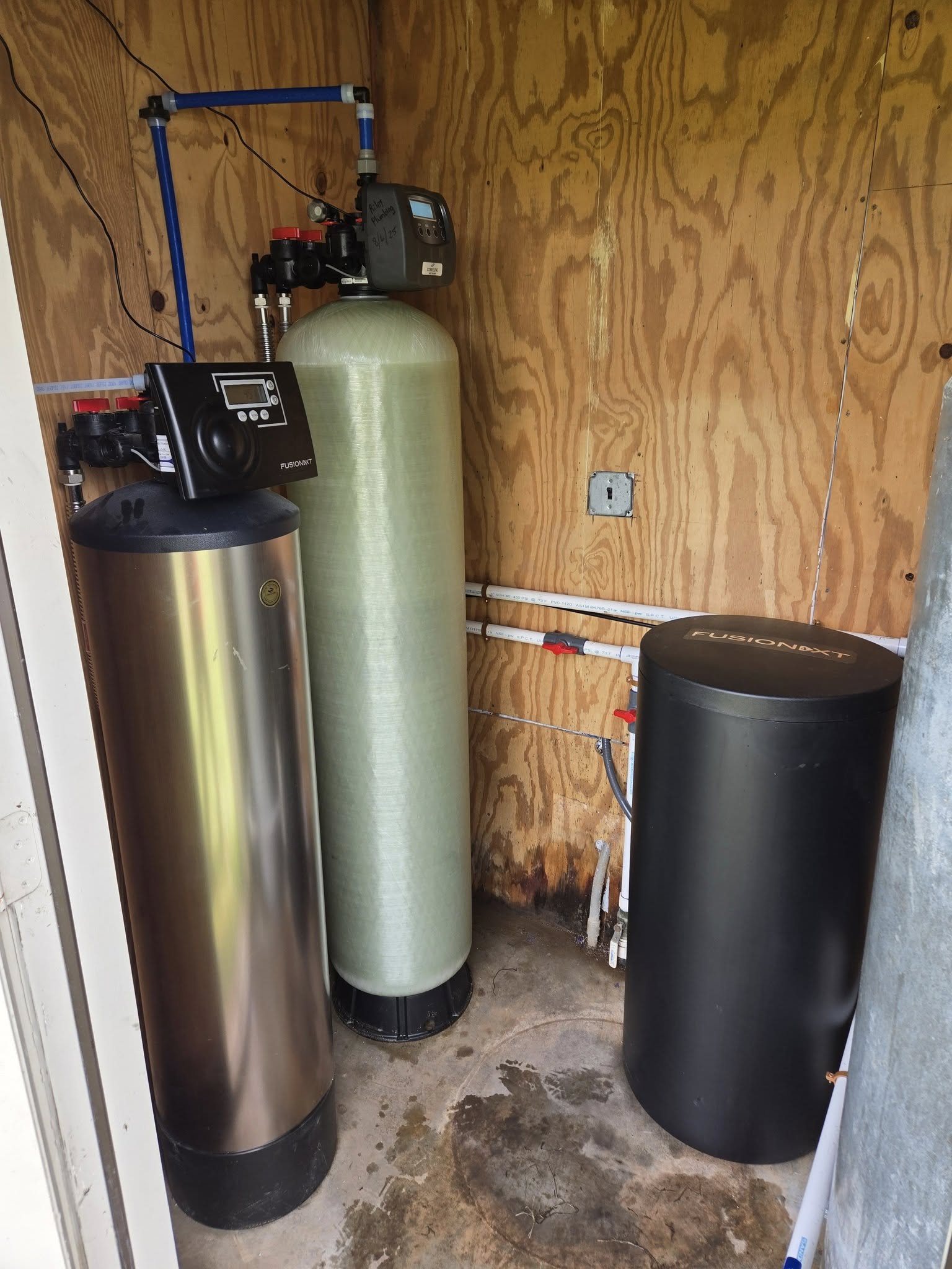 Whole-home water filtration and softener system installed in an outdoor utility shed in Brazoria County, TX