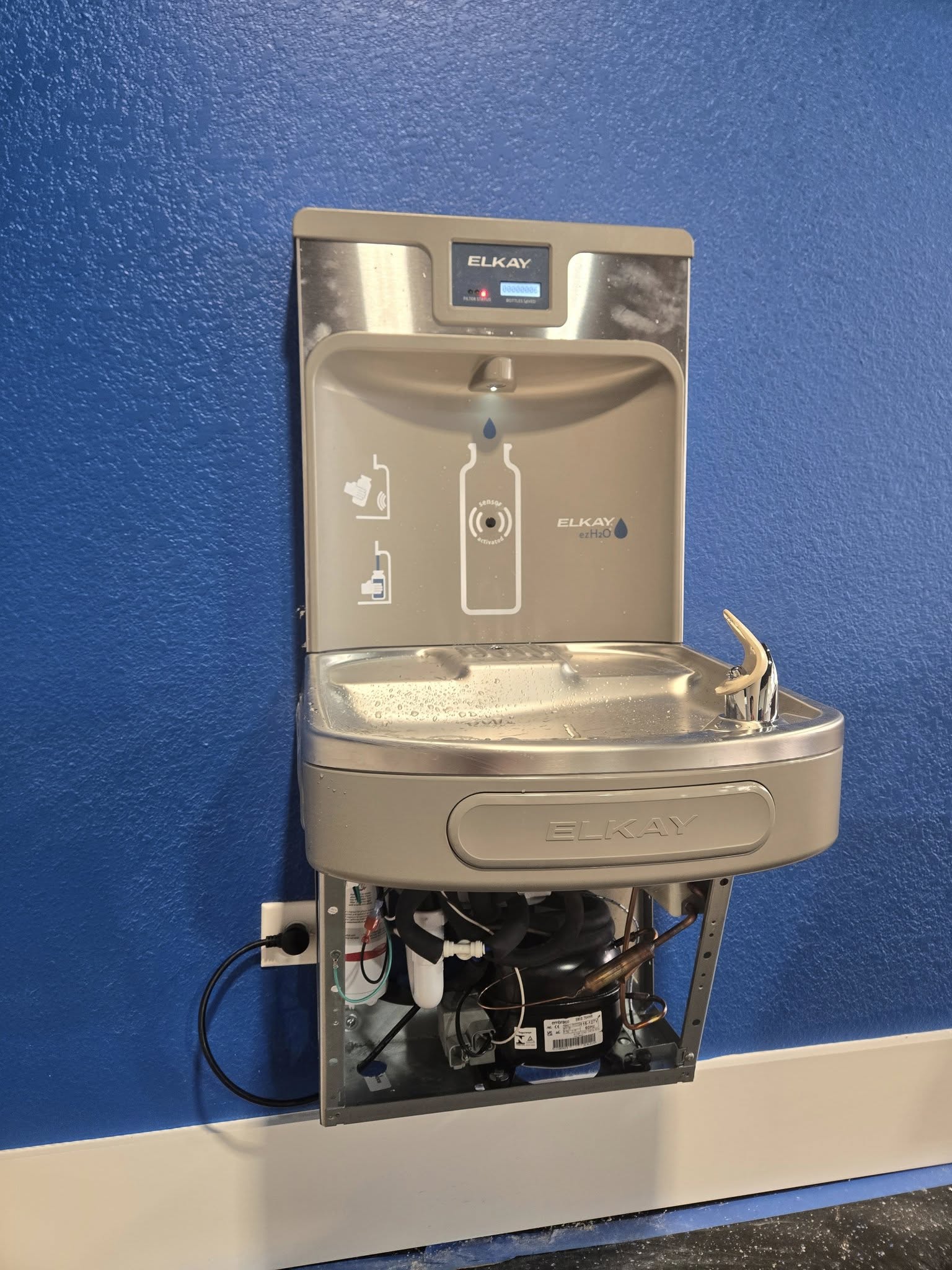 Commercial Elkay water fountain with exposed service panel